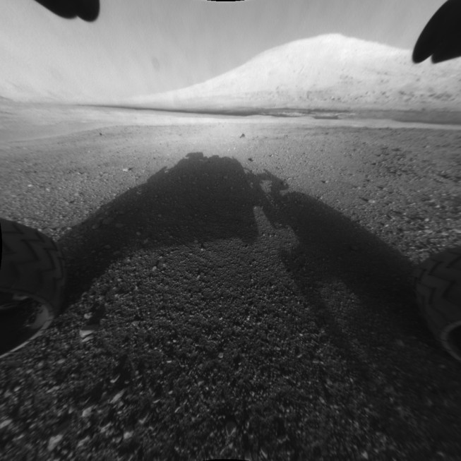 Taken after the landing—rover shadow in the foreground, Mount Sharp in the background. Photo: NASA/JPL-Caltech. 